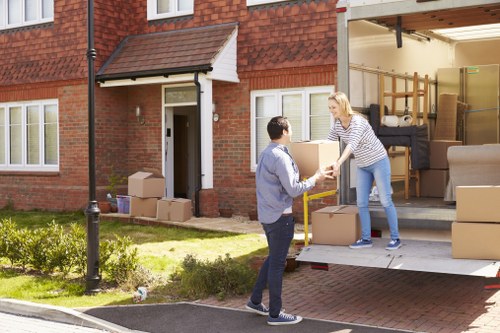 Removal van and home moving boxes in a Lambeth residential street