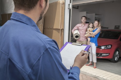 Two movers carrying boxes from a flat in Lambeth