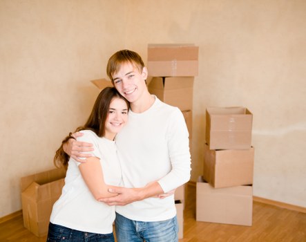 Professional movers loading boxes and furniture into a removal van